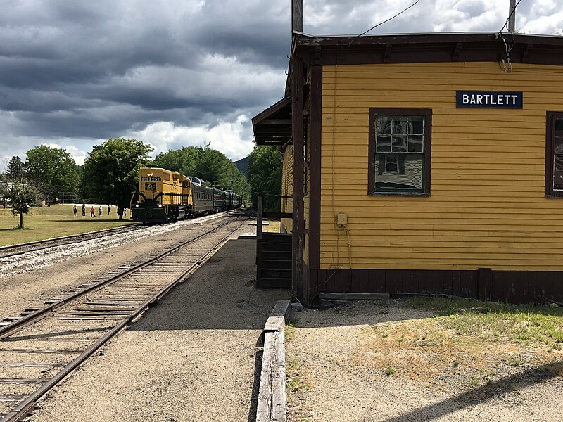 Conway Scenic Railroad traveling through Crawford Notch during fall foliage season